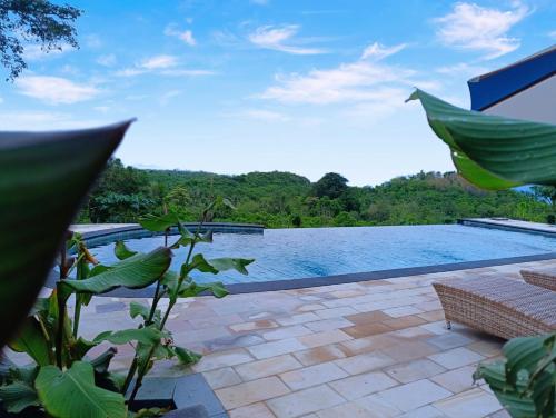 a view of a swimming pool from a house at Kubuhill Sunset Bungalow in Nusa Penida