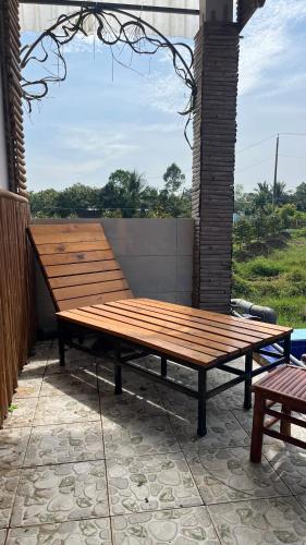 a wooden picnic table sitting on top of a patio at Can Tho Farmstay in Cái Răng