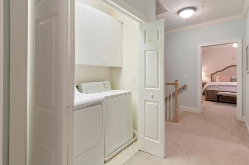 a white kitchen with a sink and a bedroom at OG23: 23 Ocean Green in Kiawah Island