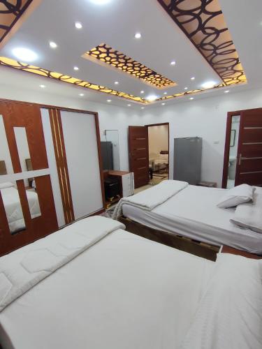 a bedroom with two beds in a room at Seuiet Hs شهاب in Cairo