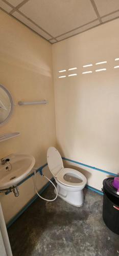 a bathroom with a toilet and a sink at Farm Bungalow in Ao Nam Mao
