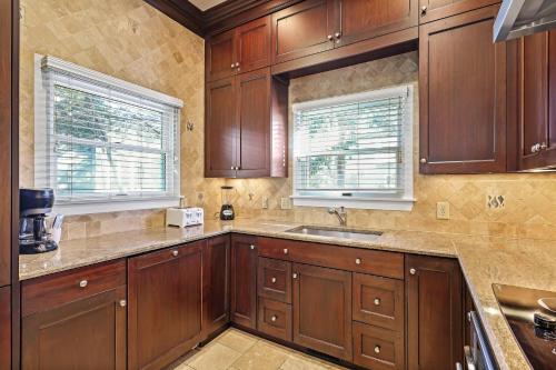 a kitchen with wooden cabinets and a sink at AB15: 15 Atlantic Beach in Kiawah Island
