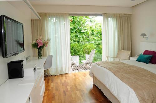 Una cama o camas en una habitación de Ilum Experience Home