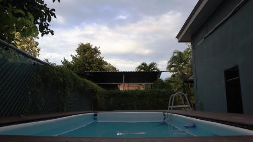 a small swimming pool in the backyard of a house at Nani House in Montezuma