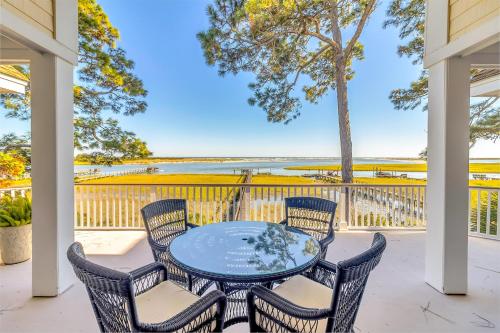 a table and chairs on a patio with a view of the ocean at MG3083: 3083 Marshgate in Seabrook Island