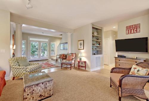 a large living room with a flat screen tv at OG02: 2 Ocean Green in Kiawah Island