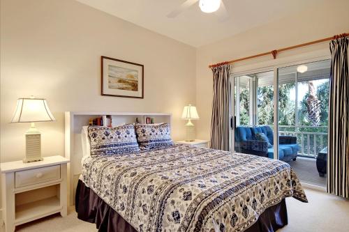 a bedroom with a bed and a large window at OG02: 2 Ocean Green in Kiawah Island
