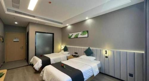 a hotel room with two beds in a room at Thank Inn Jiangsu Suqian Sucheng District Car Town in Suqian