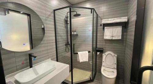 a bathroom with a shower and a sink and a toilet at Thank Inn Jiangsu Suqian Sucheng District Car Town in Suqian