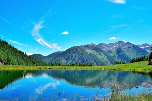 a view of a lake with mountains in the background at Casa Bamby in Cogolo