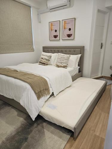 a bedroom with two beds with white sheets and pillows at Nalahost 2BR oceanview Apartment in Male City