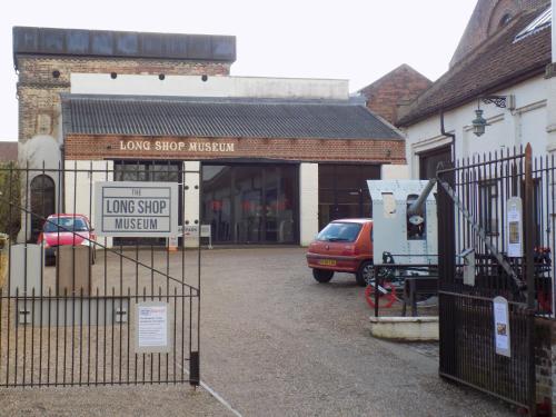 a store with a gate in front of a parking lot at The White Horse Hotel in Leiston