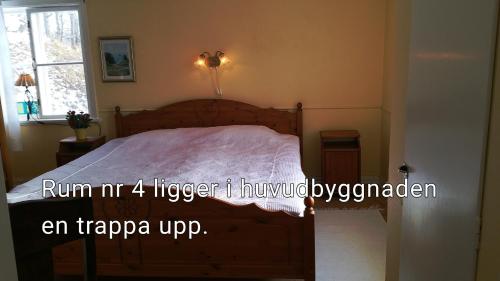 a bedroom with a bed with a white comforter at Stora Djulö Vandrarhem in Katrineholm