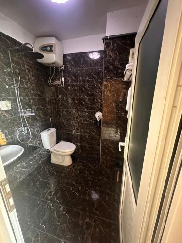 a bathroom with a toilet and a sink and a shower at Khách sạn Vĩnh Lộc in Lao Cai