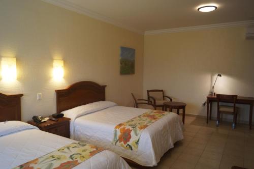 Postel nebo postele na pokoji v ubytování Hotel Argento