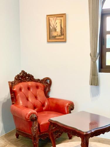 a red leather chair and a table in a room at Villa San Diego in Puli
