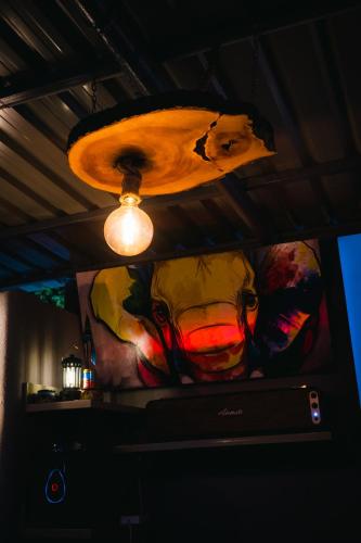 a painting on the wall in a room with a light at The L Boutique Tz in Dar es Salaam