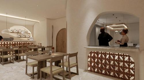 a restaurant with wooden tables and a woman in a mirror at Paul Marie in Hersonissos