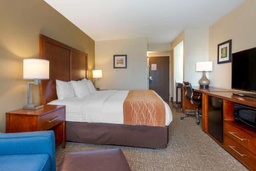 a hotel room with a bed and a desk with a computer at Comfort Inn & Suites Wilkes Barre - Arena in Wilkes-Barre