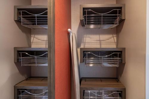 a walk in closet with two tiers of cages at Hilton Garden Inn Fredericton in Fredericton