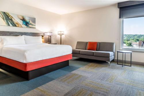a hotel room with a bed and a couch at Hilton Garden Inn Fredericton in Fredericton