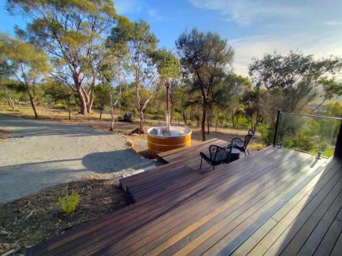 a deck with a fountain and two benches on it at Valley Views Retreat in Richmond