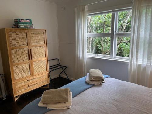 a bedroom with a large bed and a window at Maisie's Cottage in Mount Victoria