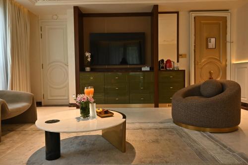 a living room with a couch and a coffee table at The Townhouse Hotel - Small Luxury Hotels of the World in Islamabad