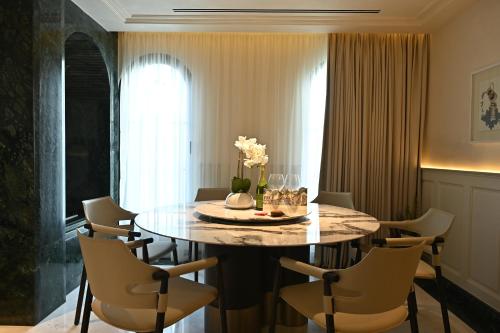 a dining room with a round table and chairs at The Townhouse Hotel - Small Luxury Hotels of the World in Islamabad