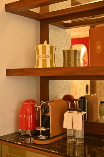 a kitchen counter with a toaster and a coffee maker at The Townhouse Hotel - Small Luxury Hotels of the World in Islamabad