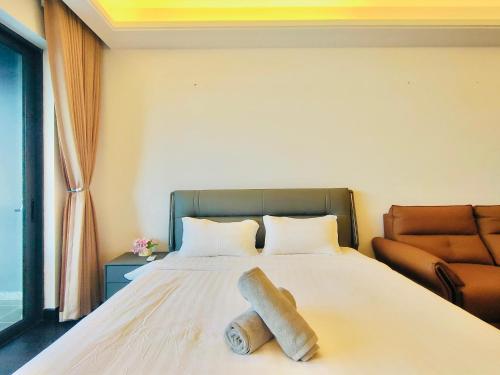 a hotel room with a bed with a towel on it at R&F Seine Region in Johor Bahru
