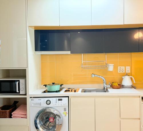 a kitchen with a washing machine and a sink at Mango&Haru House in Seoul