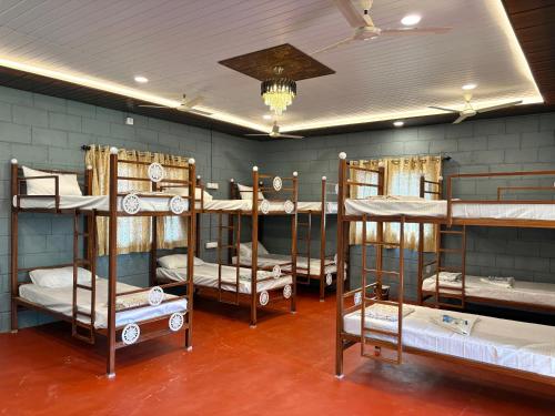 a room with four bunk beds in it at Mowgli's Cafe Hampi & Guest House in Hampi