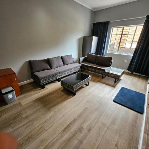 a living room with a couch and a table at Da Vinci Palms in Witbank