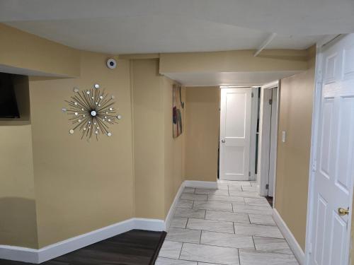 a hallway with a clock on the wall at Spacious Basement Apartment near metro downtown Washington DC in Capitol Heights