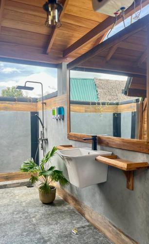 a bathroom with a sink and a potted plant at Private Pool Sun Shade Resort & Spa in Habarana