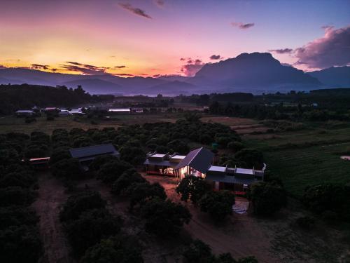 an aerial view of a house in a field at sunset at Daraga ดารกะ in Chiang Dao