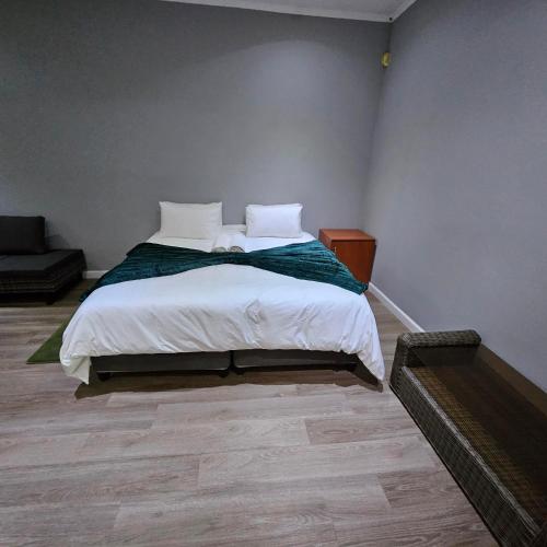 a bedroom with a bed with white sheets and pillows at Da Vinci Palms in Witbank