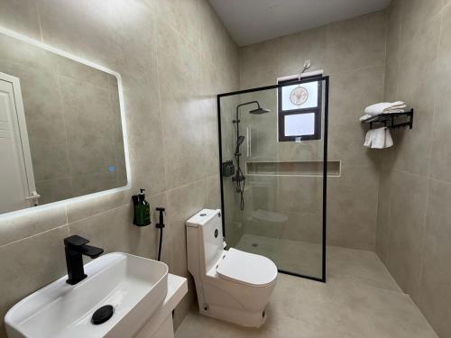 a bathroom with a toilet and a sink and a shower at The Balance Retreat in Būbādī