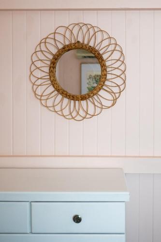 a mirror hanging on a wall above a dresser at Heavenly Palms on Collinson in Westcourt