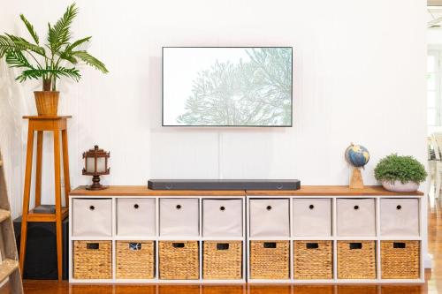a living room with a white dresser at Heavenly Palms on Collinson in Westcourt