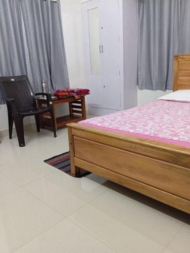 a bedroom with a bed and a table and chairs at Blessing Homestay in Pūvār