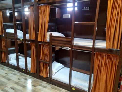 a group of bunk beds in a room at Unibed Dormitory in Mumbai