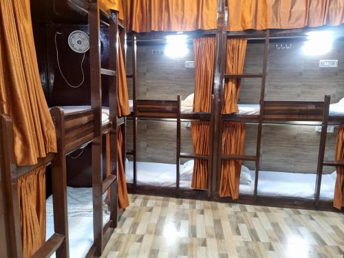 a room with several bunk beds in a room at Unibed Dormitory in Mumbai
