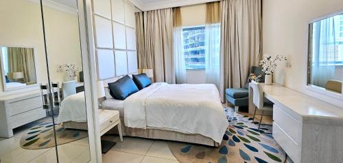 a hotel room with a bed and a mirror at Superb 1 BR apt next to Burj Khalifa and Dubai mall in Dubai