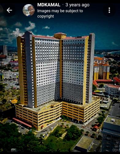 a large building in a city with the words moxyhazard years ago images at Aisy Homestay in Kuala Terengganu