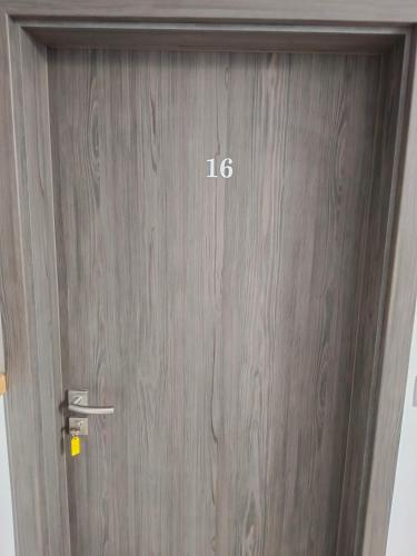 a wooden door with the number on it at Penzion Mušov in Pasohlávky