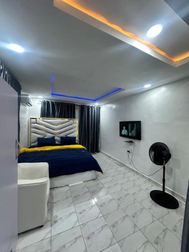 a bedroom with a bed and a chair in a room at Beautiful single room studio apartment in Ilasan lekki magnanimous in Lekki