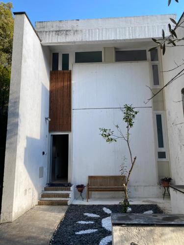 a white building with a bench in front of it at Casa Salima a Deiva Marina tra 5 Terre e Portofino in Deiva Marina