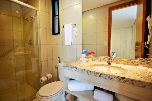 a bathroom with a sink and a toilet and a shower at Comfort Hotel & Suites Natal in Natal